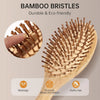 A wooden bamboo brush with bristles is shown, demonstrating massage and promoting blood circulation for fluffy hair.