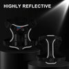 A black reflective service dog harness is displayed on a stand, highlighting its features.