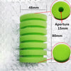 A stack of green biological aquarium sponge filter discs with various aperture sizes and dimensions.