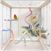 A colorful bird rope perch stand with various colored ropes suspended in a modern white aviary enclosure.