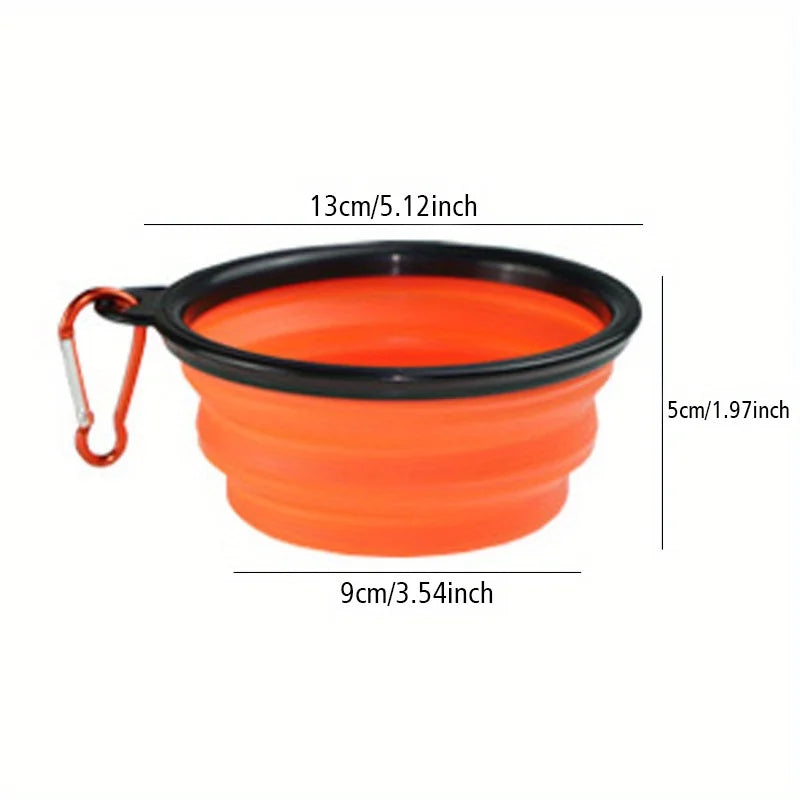 Orange silicone dog travel bowl with a black rim and attached strap.