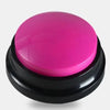 A round, bright pink button with a black base for dog training.