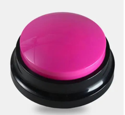 A round, bright pink button with a black base for dog training.