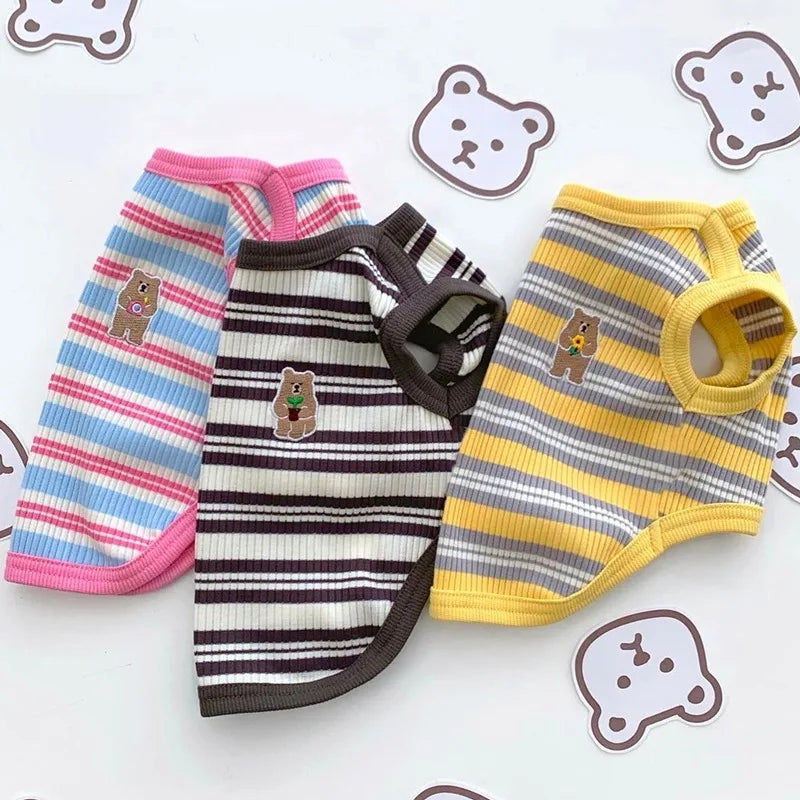 A set of striped stretchy pet tank tops for cats and small dogs in pink, purple, and yellow.