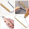 Close-up view of a manual lint remover brush with wooden handles and metal blades used for removing lint and pet hair from fa