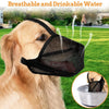 A golden retriever wearing a black comfort mesh dog muzzle with adjustable straps in a grassy outdoor setting.