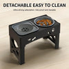 A black detachable elevated dog bowl stand with a stainless steel bowl for pet food