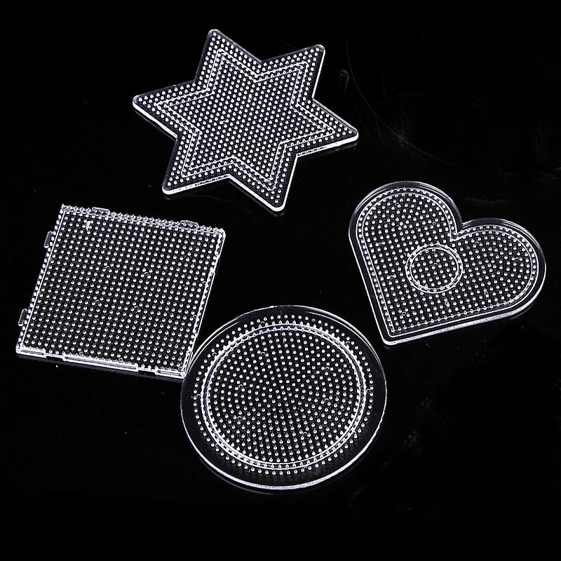 A collection of precision hama beads shapes including a star, heart, and circle, displayed on a black background.