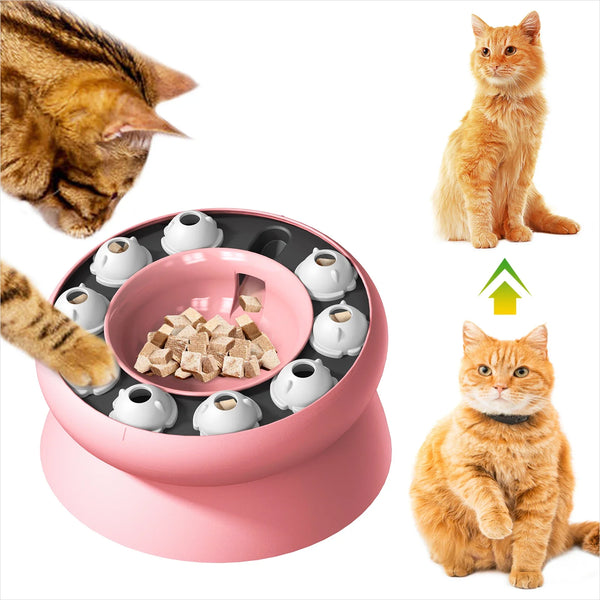 A pink interactive slow feeder cat puzzle bowl with kibble and a cat nearby.