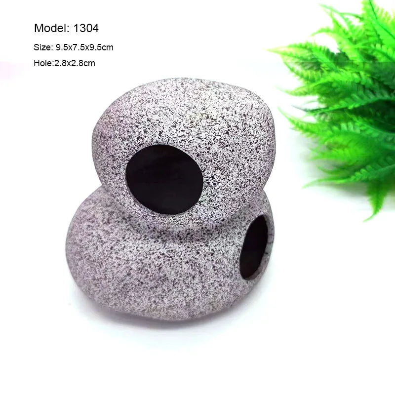 A smooth, gray ceramic cichlid cave aquarium decor piece with two holes.
