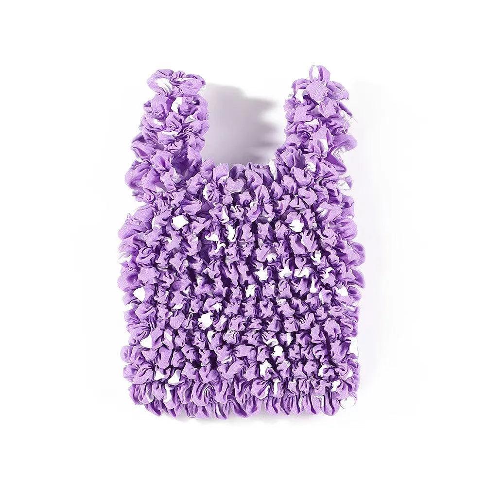 A purple reusable foldable bubble shopping bag covered in ruffled fabric.