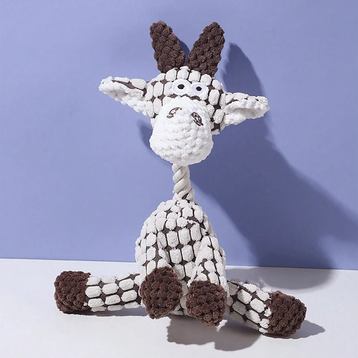 A white and brown plush toy shaped like a donkey with large ears.