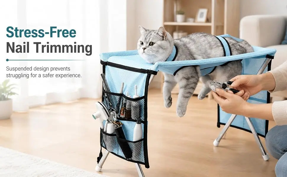 A cat is resting in a blue pet grooming hammock designed for stress-free nail trimming.