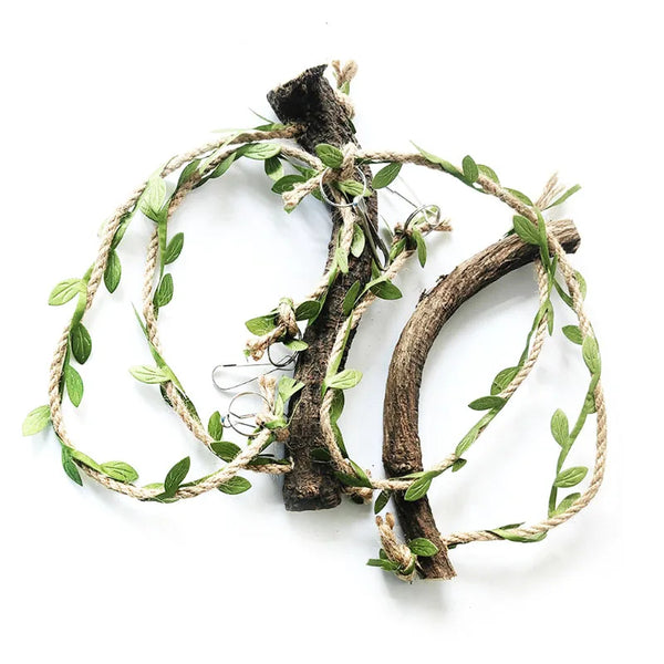 A natural wood parrot swing and climbing toy made from branches and green vines.