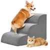 An orange and white dog is jumping onto a gray foam pet stairs ramp.