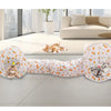 A foldable cat play tunnel with a patterned fabric is shown lying on a light floor.