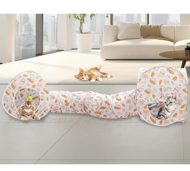 A foldable cat play tunnel with a patterned fabric is shown lying on a light floor.