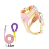 A pink and yellow adjustable no-pull dog harness with reflective straps is shown against a white background.
