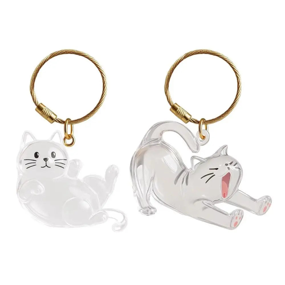 A clear silicone cat figurine keychain with a gold-colored loop and jump ring.