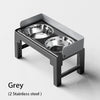 A grey collapsible elevated dog feeder featuring two stainless steel bowls.