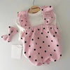 A pink summer dot pet dress for a small dog, featuring ruffled trim and black polka dots.