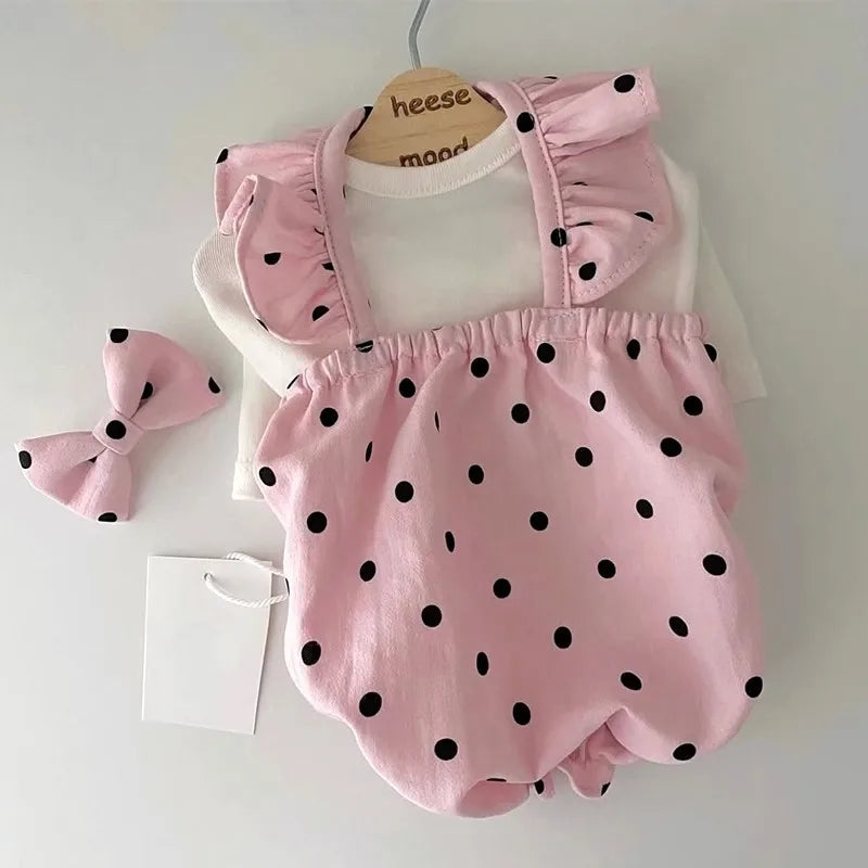 A pink summer dot pet dress for a small dog, featuring ruffled trim and black polka dots.