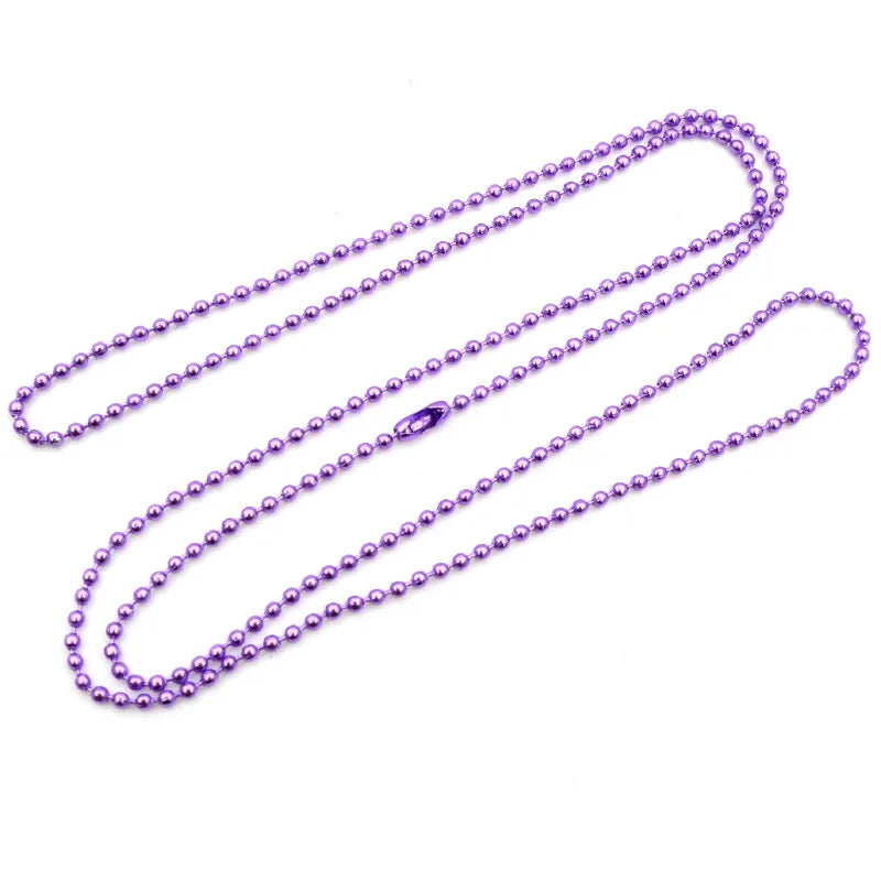 A set of purple plated ball bead necklaces laid out on a white background.