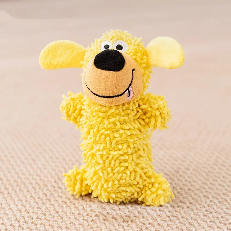 A yellow plush dog toy with large floppy ears and a black nose on a beige background.