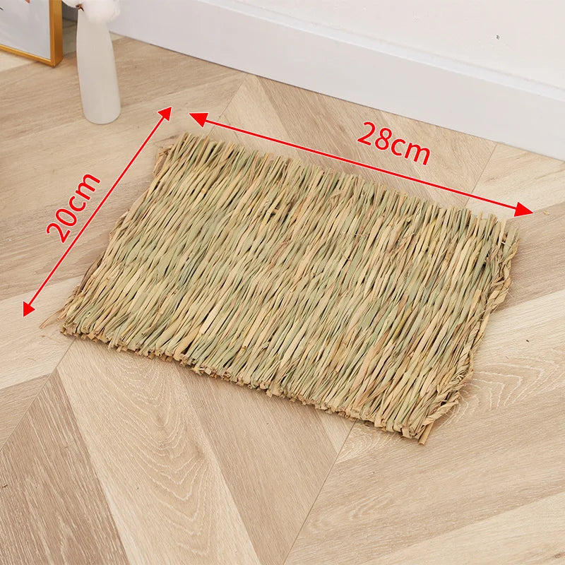 A rectangular mat woven from natural straw placed on a light wood floor.