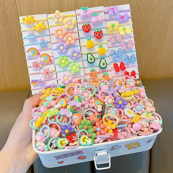 A bulk pack of colorful cartoon hair ties for girls arranged in a grid and displayed in a box.