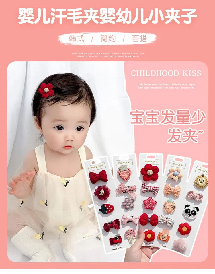 A close-up photo of a baby wearing a white outfit, with several pink and red flower-shaped hair clips displayed in a packagin