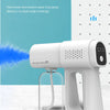 A white electric nano spray gun is shown next to a clear spray bottle on a marble surface.