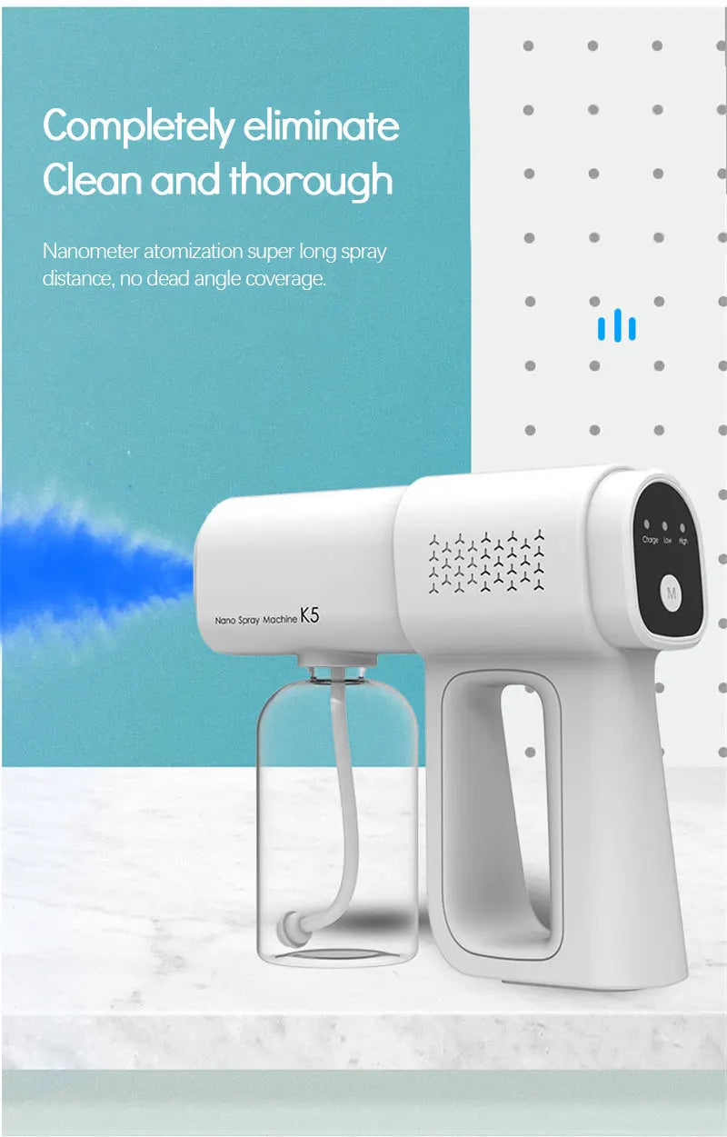 A white electric nano spray gun is shown next to a clear spray bottle on a marble surface.