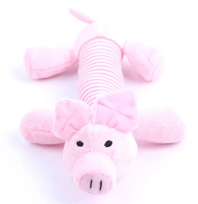Pink plush toy shaped like a dragon or dinosaur with pink ears and a striped body