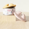 A silicone pet can opener and feeding spoon with a sealing lid is shown next to its yellow and pink components.