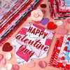 A collection of pink and red Valentine's Day themed items including heart-shaped fabric pieces and dog bandanas.