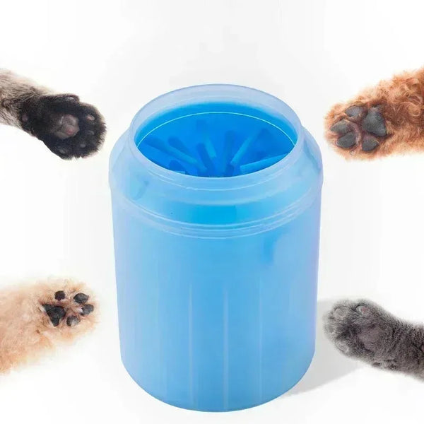 A blue cup for washing dog paws with soft silicone cleaning bristles, shown next to several dirty paws.