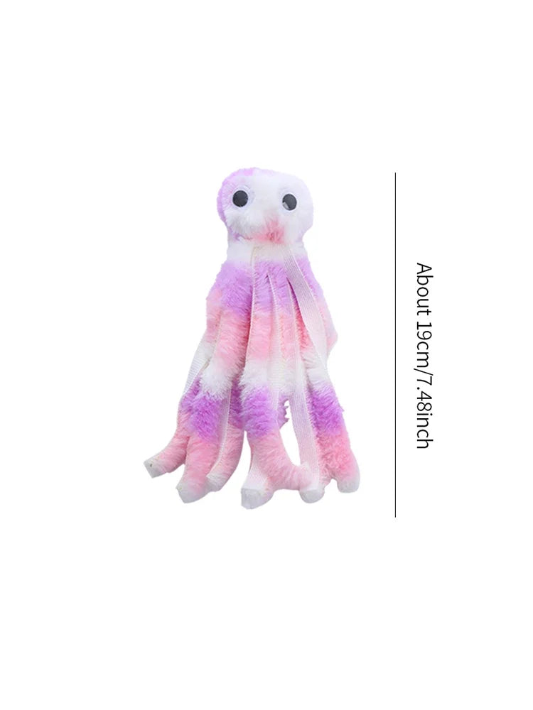 A fluffy pink and purple catnip octopus plush toy with large white eyes.