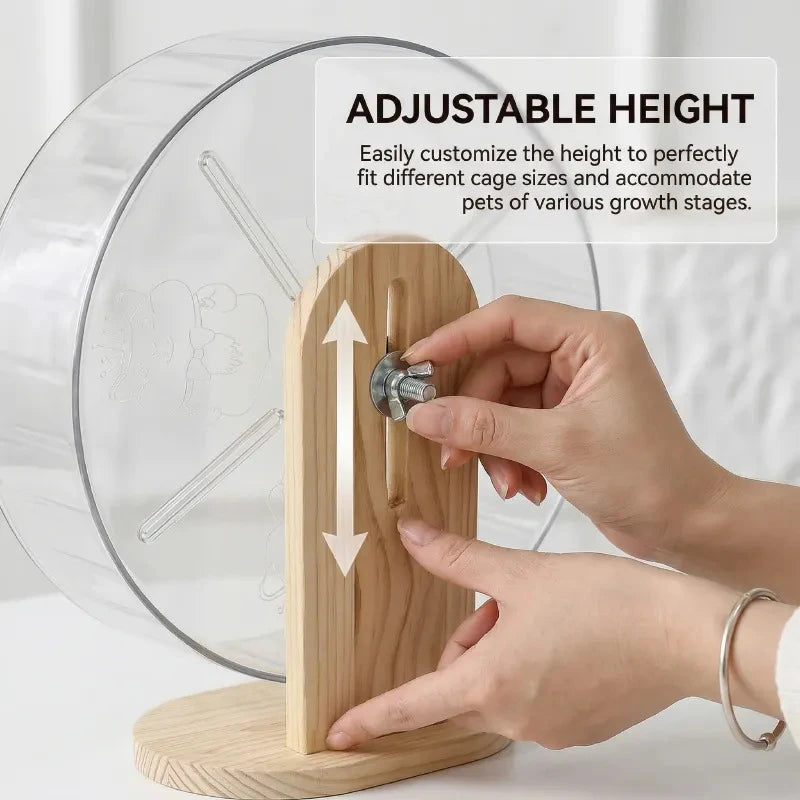 A hand adjusts the height of a hamster silent running wheel with a wooden stand to fit different cage sizes.