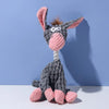 A gray plush toy shaped like a donkey with pink ears and a pink nose, featuring a teeth cleaning texture.