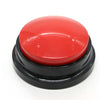 A round, bright red button with a black base for dog training.