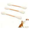 Three wooden cotton swab shaped catnip toys with white tips and a small orange kitten