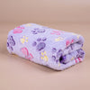 A soft purple fleece blanket featuring a pattern of pink, yellow, and purple paw prints.