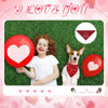 A child holding a red heart balloon next to a dog wearing a red bandana with a floral pattern.