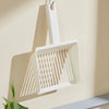A white extra-large cat litter scoop with a hanging hook is displayed on a wall.