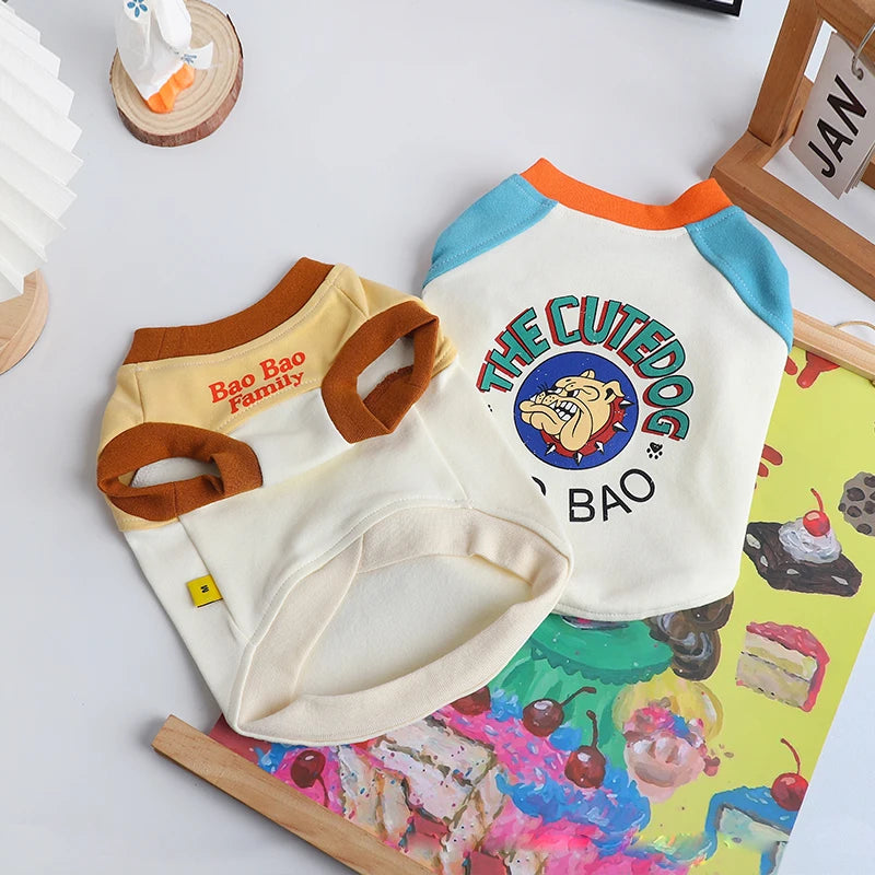 A white pet dog vest t-shirt with blue and orange trim, featuring a graphic of a dog's face.