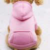 A pink cozy hooded sweatshirt for a dog is shown against a white background.
