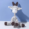 A white and gray plush toy shaped like a donkey with large ears, sitting against a light blue background.