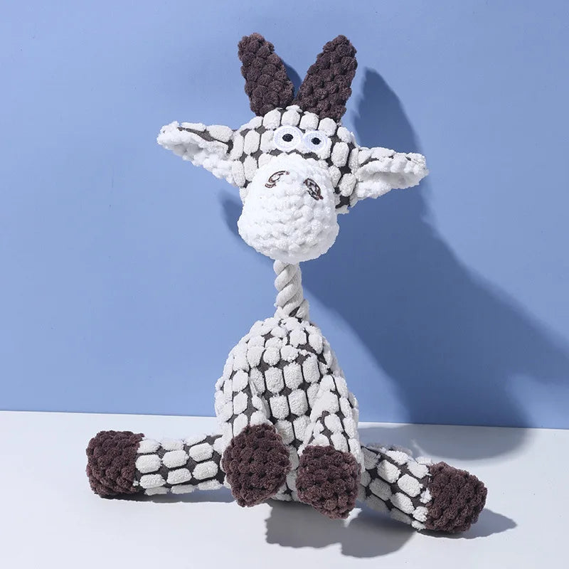 A white and gray plush toy shaped like a donkey with large ears, sitting against a light blue background.