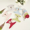 A collection of padded rabbit harness and leash sets in various pastel colors, including pink, blue, green, and red.